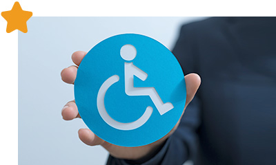 Hand holding a disability sign