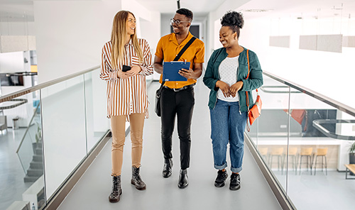 Three interns walking and talking at work - Intern Recruitment Resources