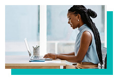 Profile view of a woman working on a laptop