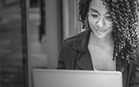 Woman smiling at a laptop