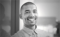 Black and white photo of a man smiling