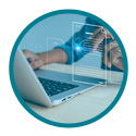 Hands typing on a laptop