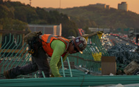 Person doing electrical work outside wearing a hardhat