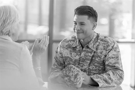 Interview Tips For Hiring Military Veterans - man in military uniform being interviewed by a woman
